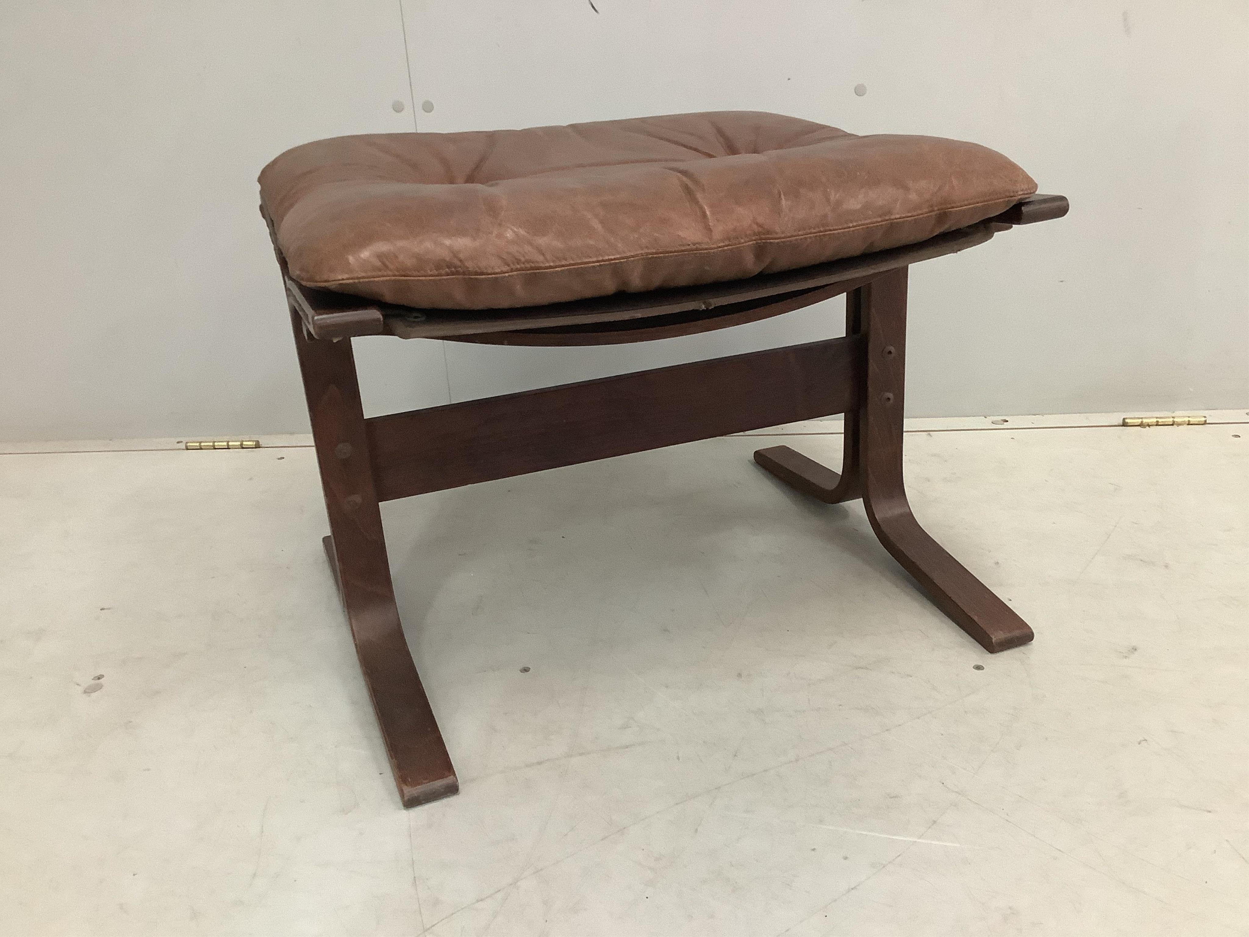 An Ingmar Relling leather chair, width 62cm, depth 66cm, height 98cm and footstool, Siesta